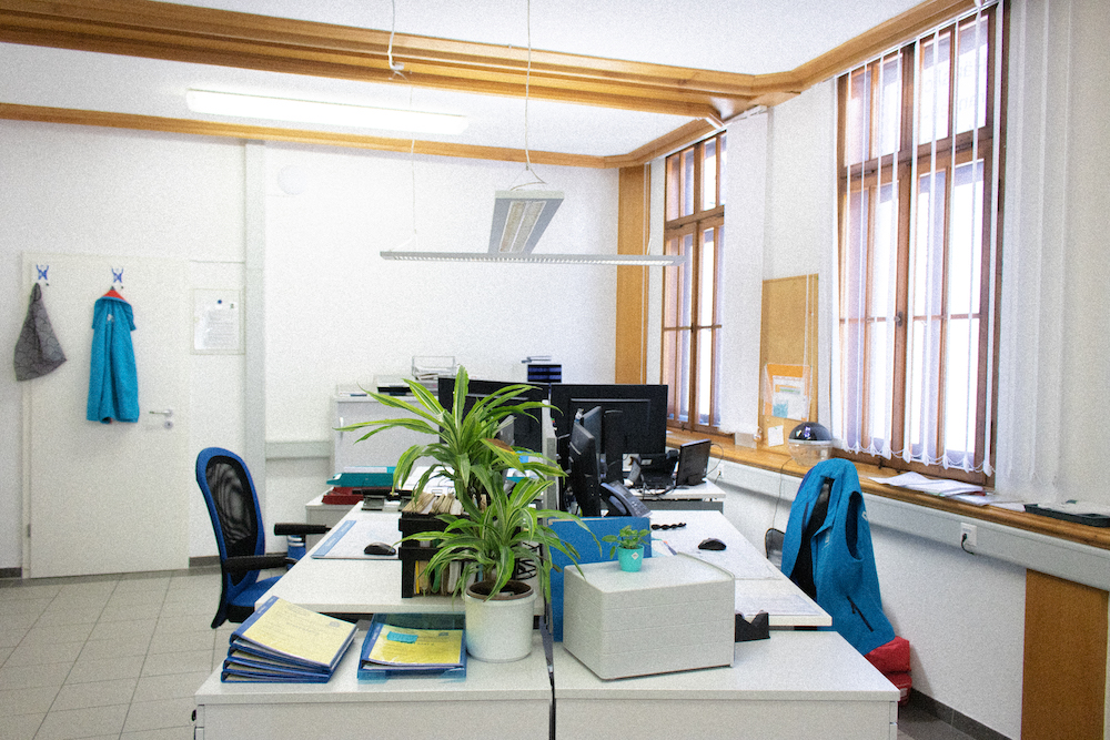 Healthcare team in blue scrubs organizing medications together at a table